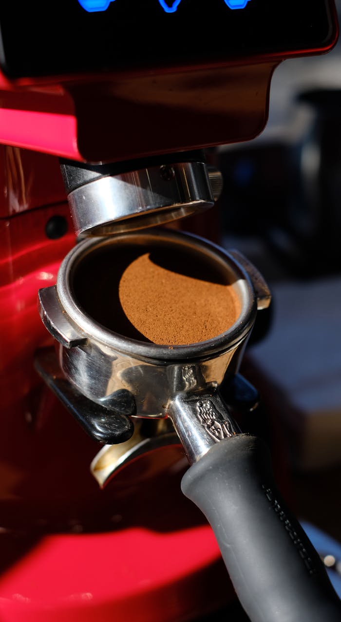 Detailed view of coffee grounds in a portafilter, ready for brewing.
